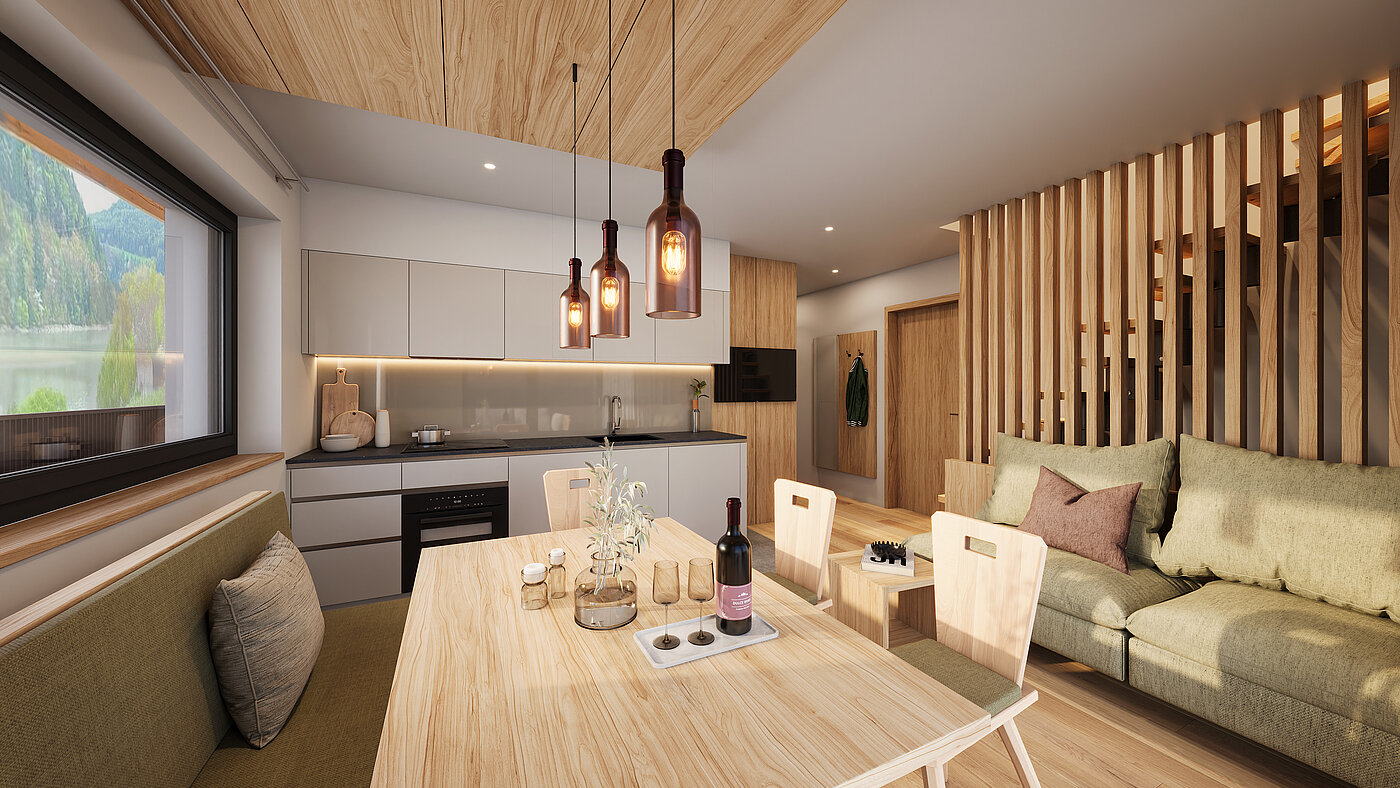 Wohnküche im Apartment | Weingut Santer Moderne Wohnküche des Apartment mit hellem Holzesstisch, hängenden Leuchten, Küchenzeile und einer Sitzecke mit Kissen.